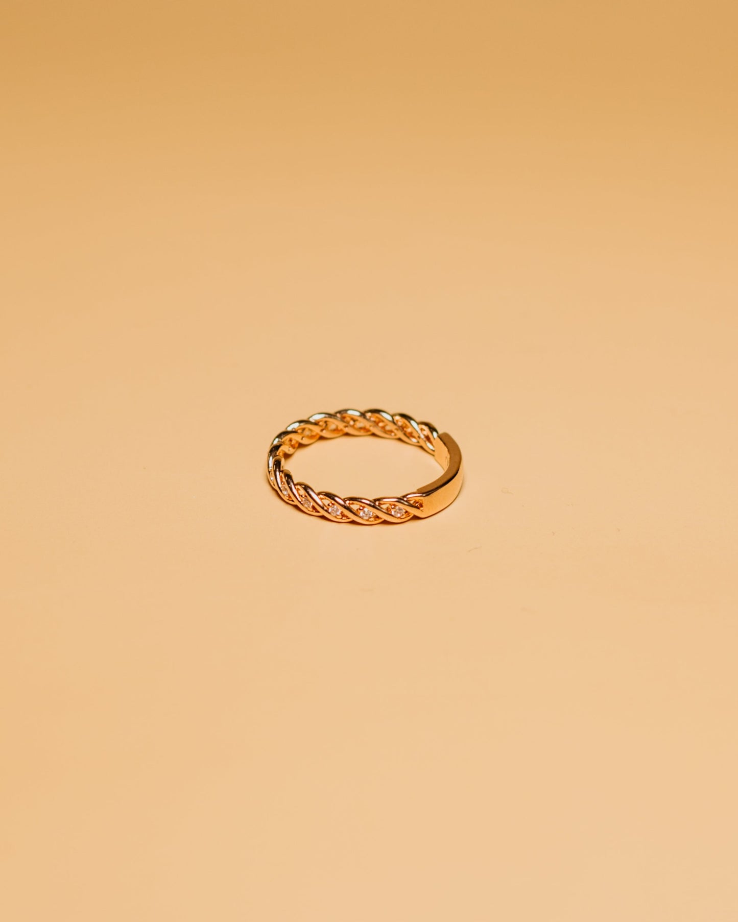 Close-up of a hand with a gold ring with stones