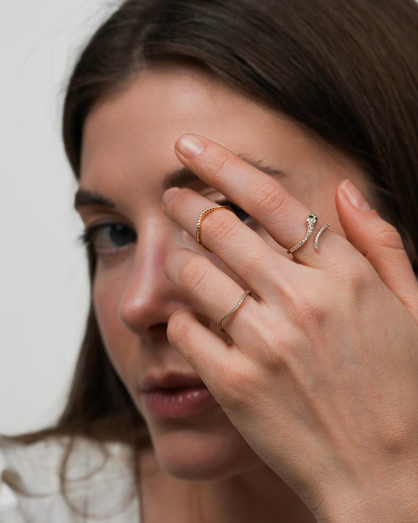 Gold plated band ring with clear cubic zirconia stones styled with other rings