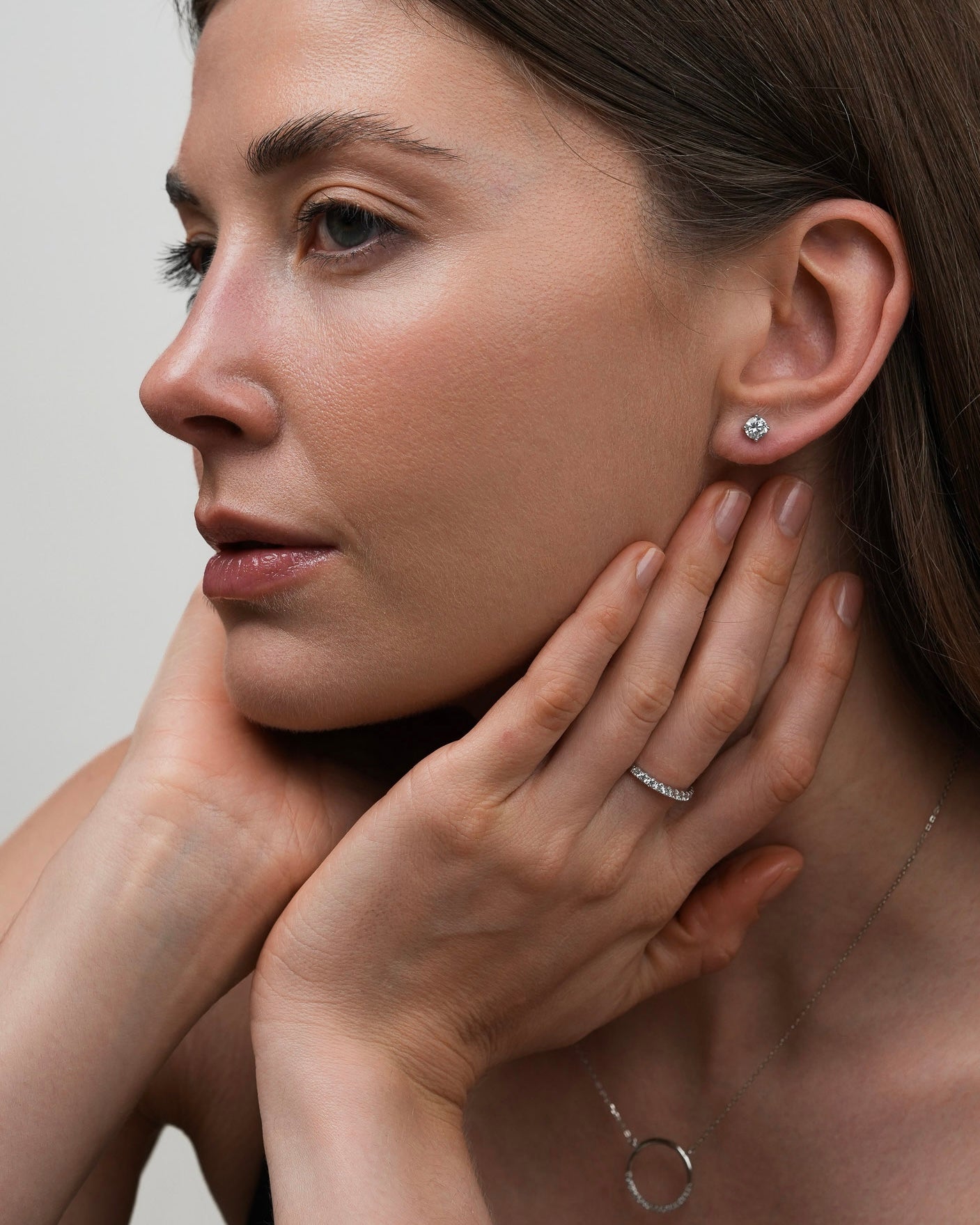 Woman wearing a 925 sterling silver half-eternity ring with cubic zirconia
