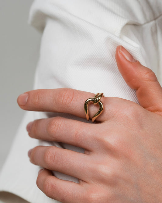 Gold-plated sculptural ring styled for everyday wear on the hand