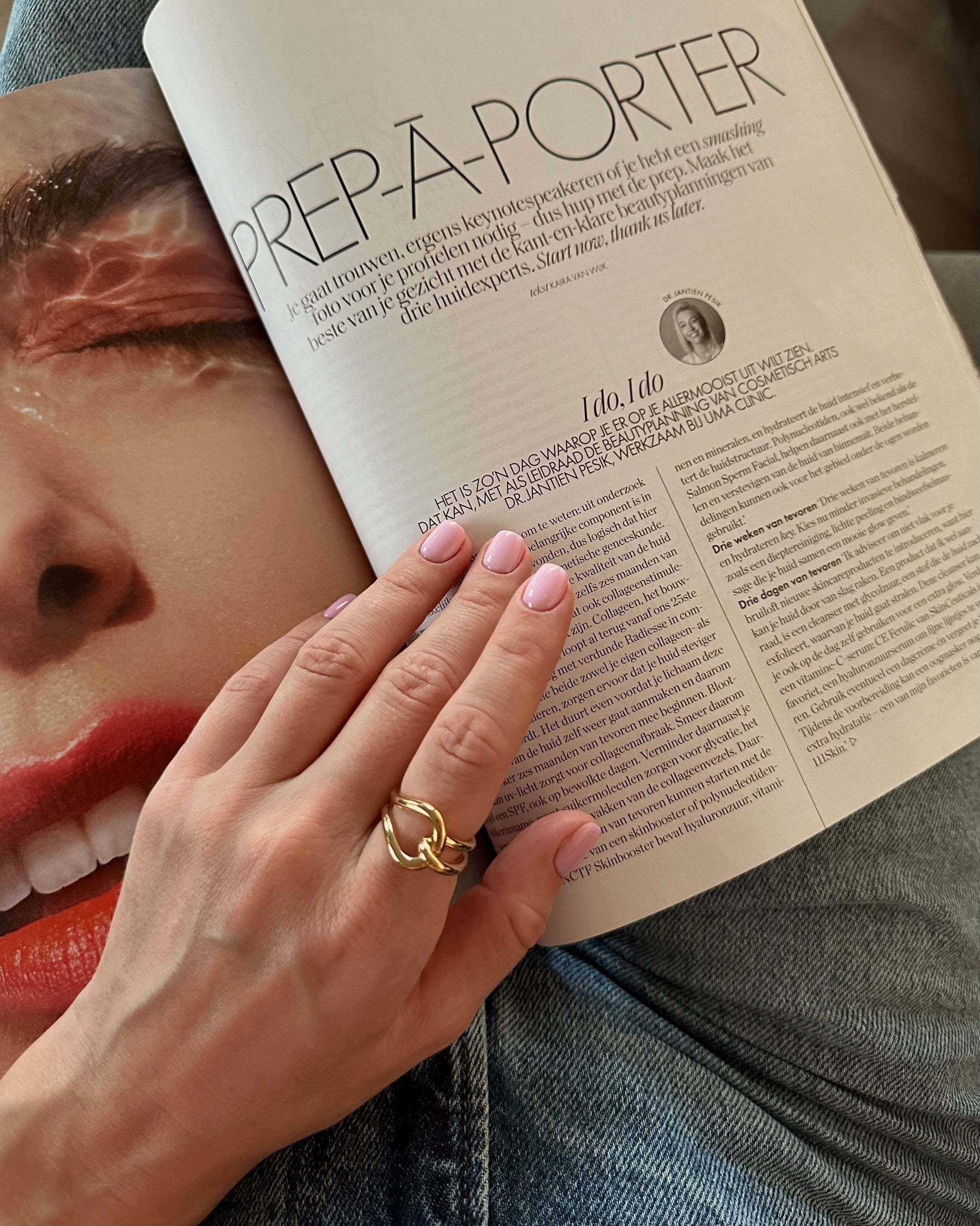 Hand with a gold ring holding an open magazine