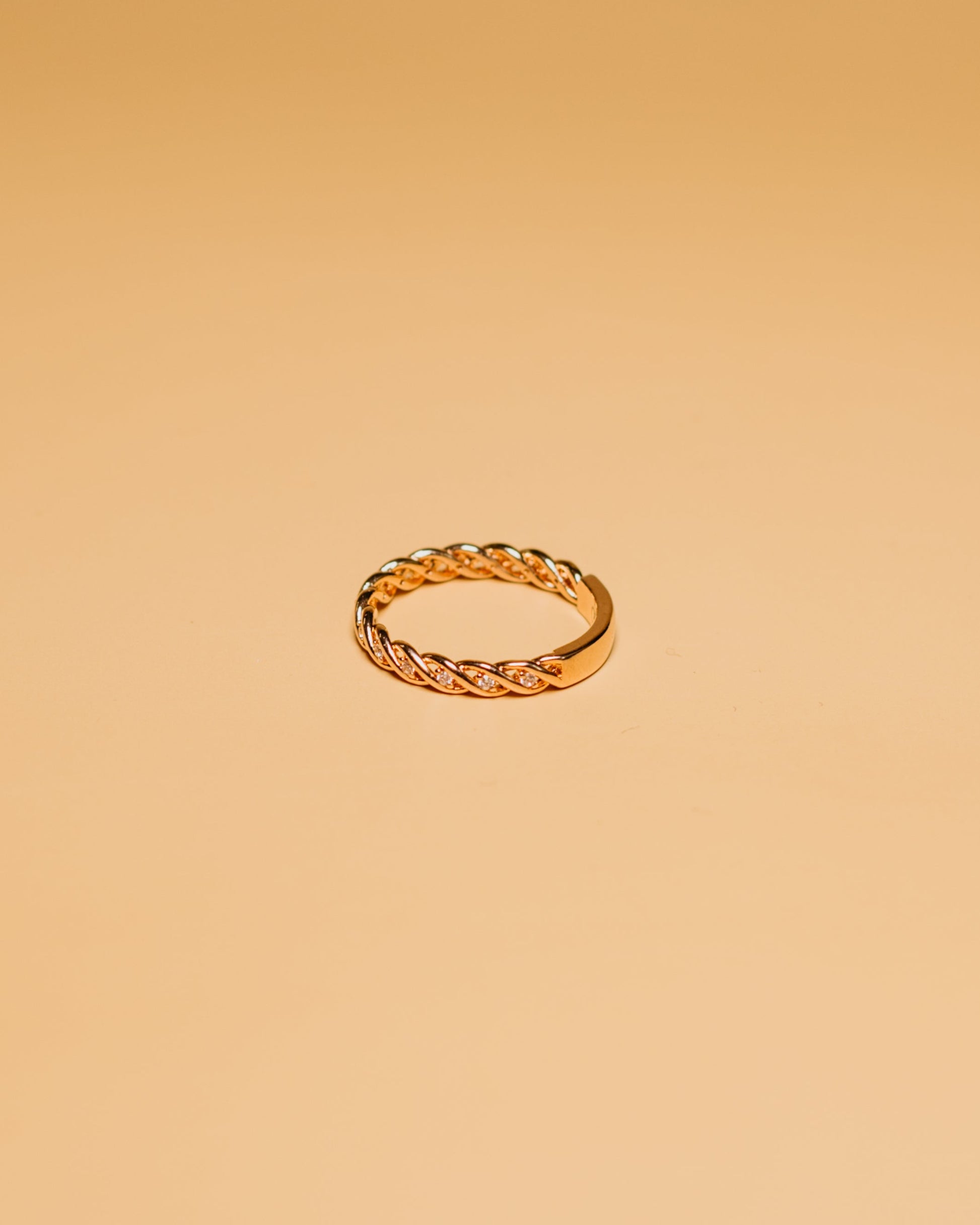 Close-up of a hand with a gold ring with stones