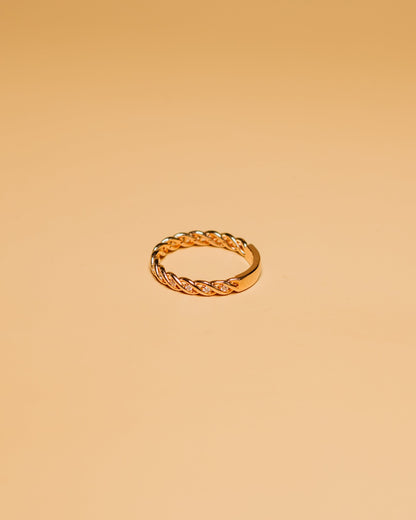 Close-up of a hand with a gold ring with stones