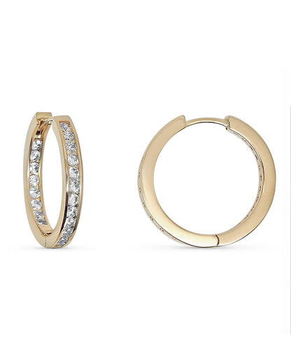Gold hoop earrings with embedded stones and a measurement scale on the right.