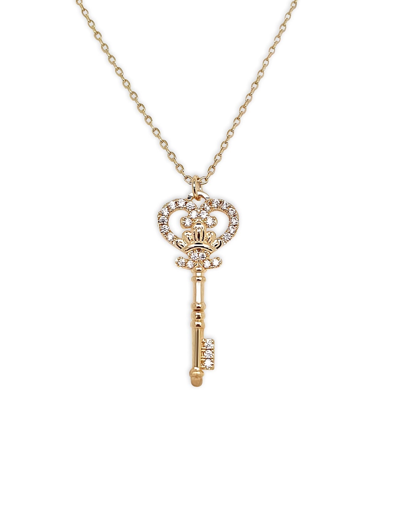 Gold key-shaped pendant necklace on a white background
