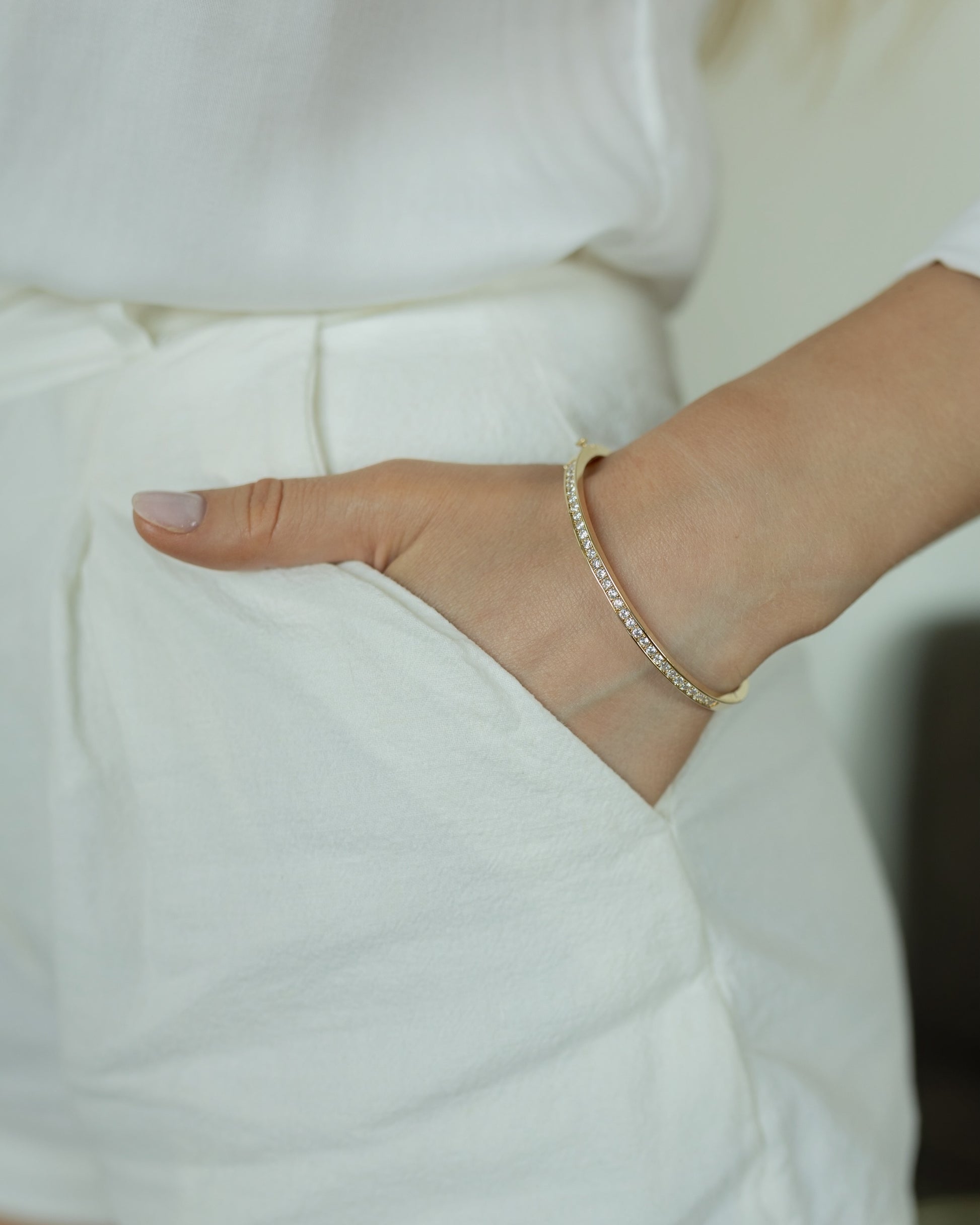 Close-up of a hand wearing a bracelet with a blurred background