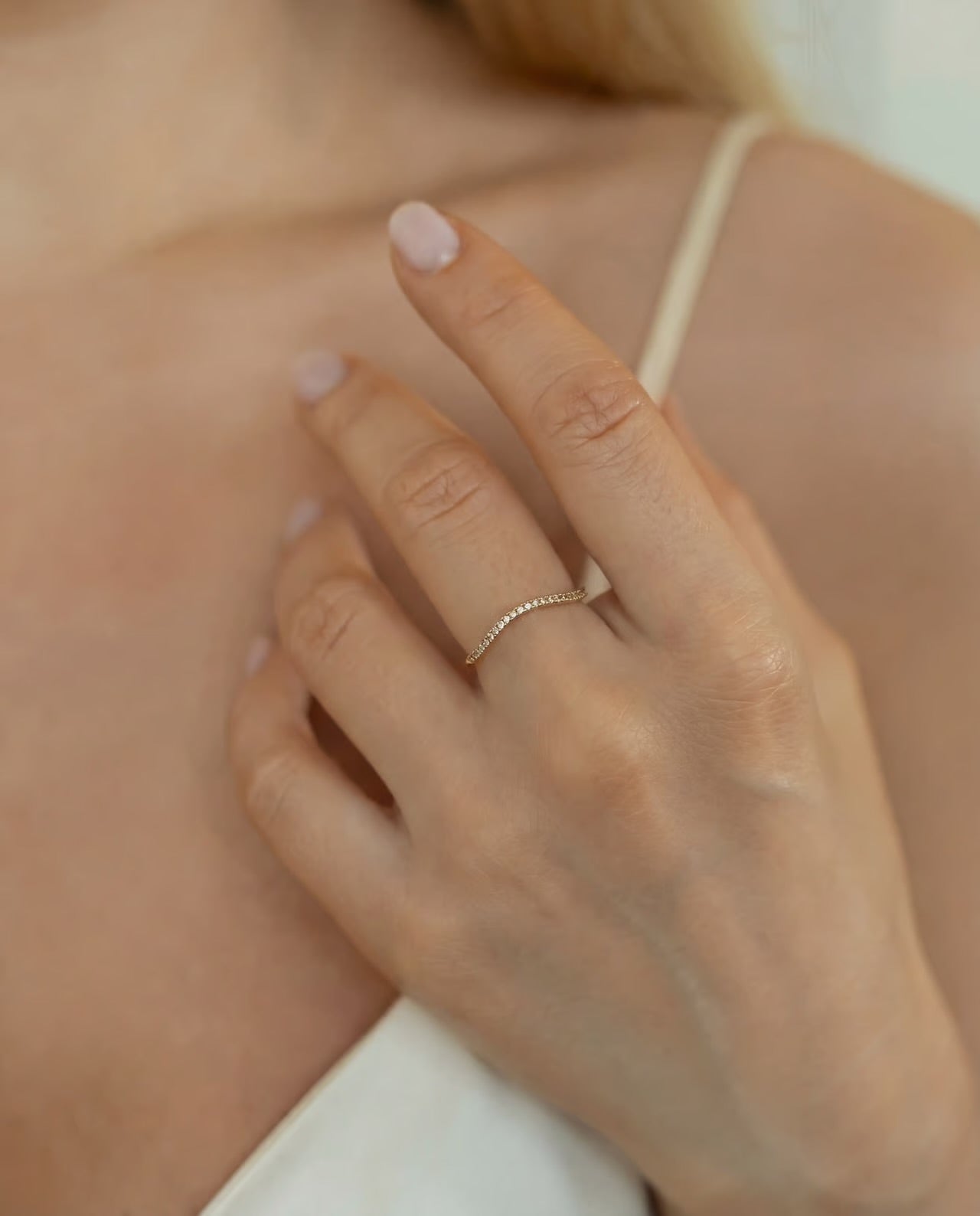 Gold plated band ring with cuboc zirconia stones in natural light, minimalist style