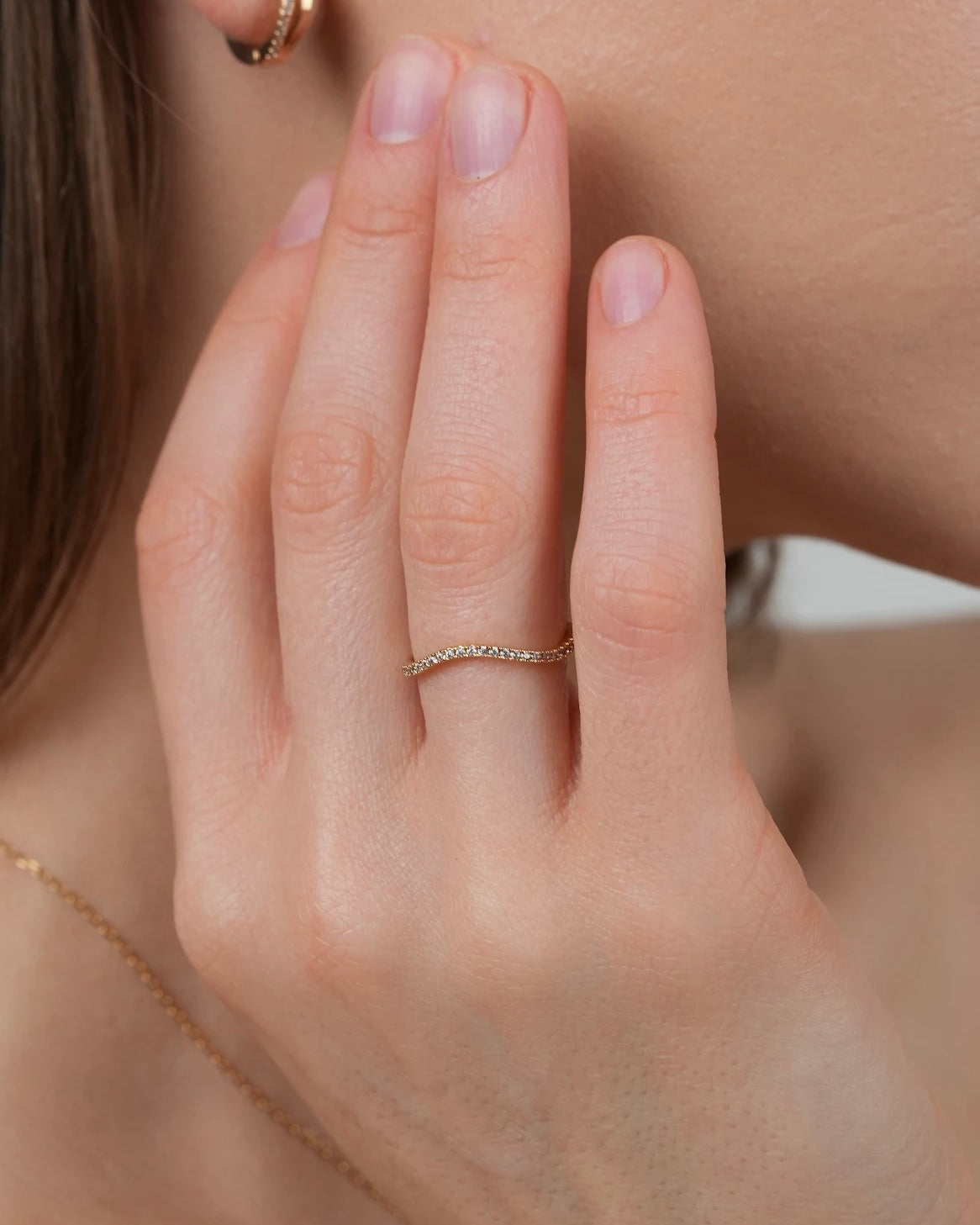 Gold plated band ring with cubic zirconia stones worn on hand, everyday minimalist ring