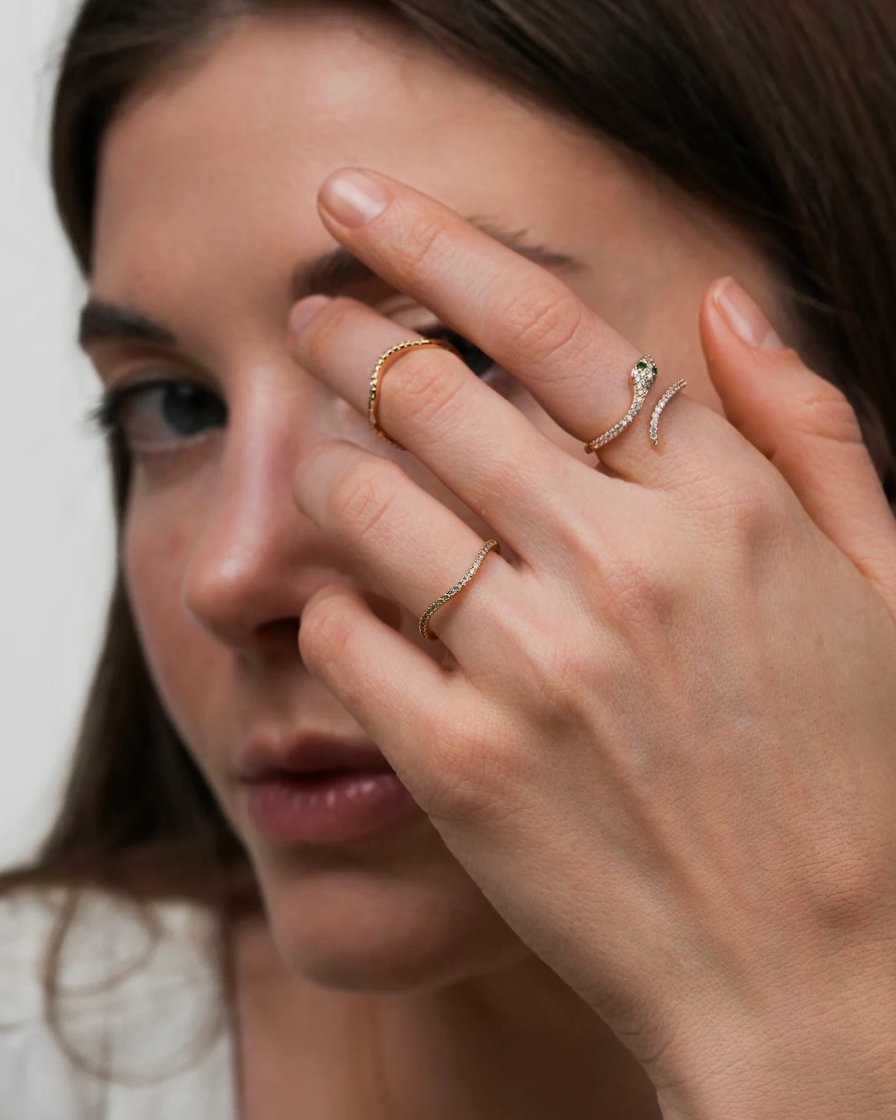 Gold plated band ring with clear  cubic zirconia stones styled with other rings