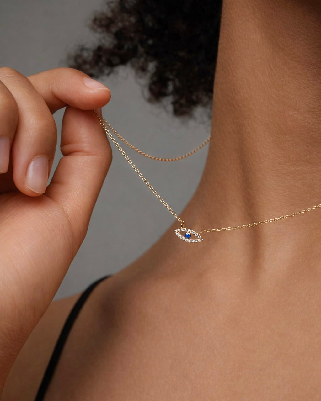 Gold plated evil eye necklace worn on the neck