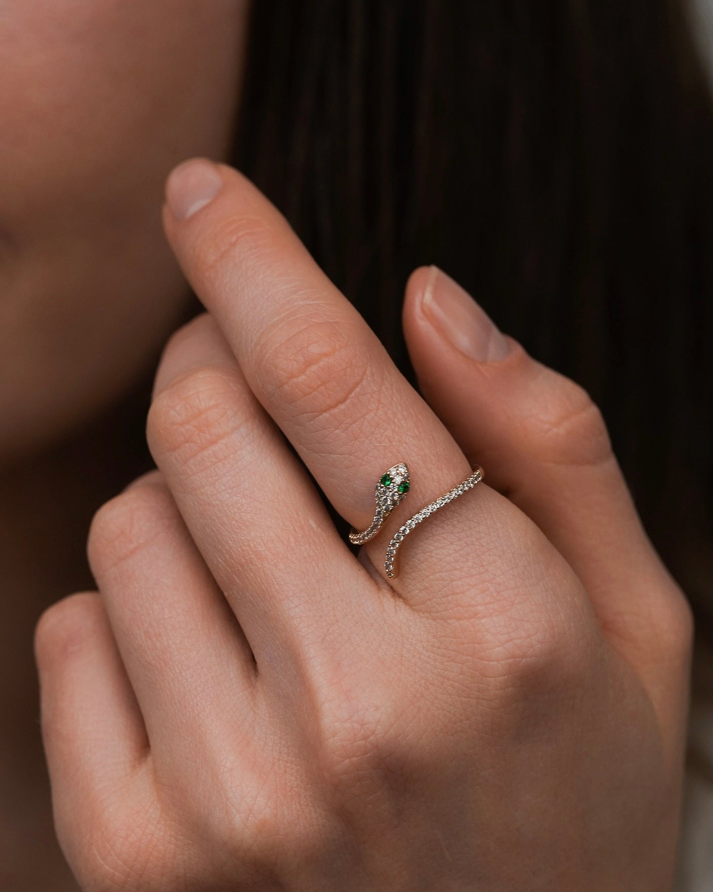 gold snake ring with cubic zirconia worn on finger for women