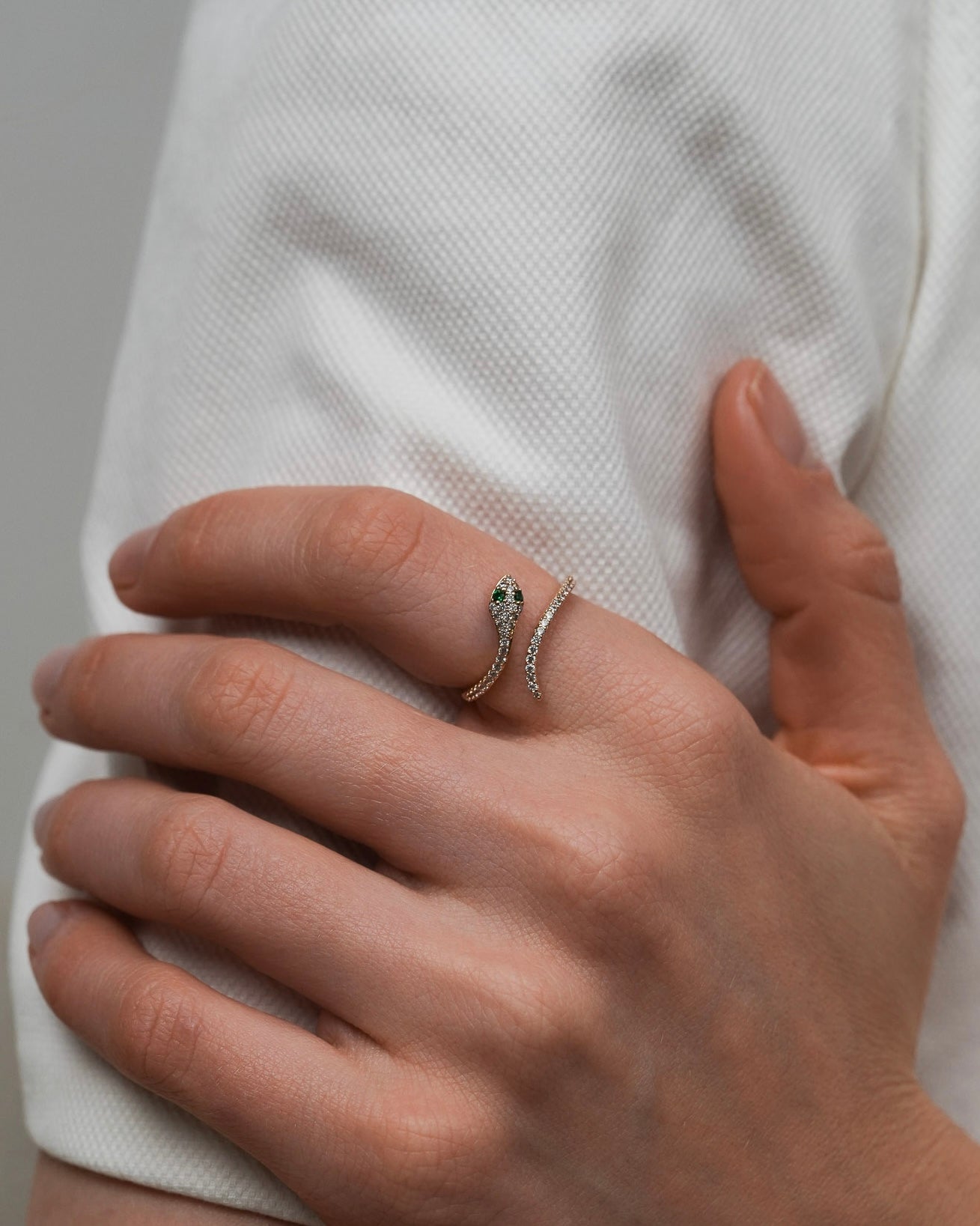 snake ring with cubic zirconia worn on hand close-up for women