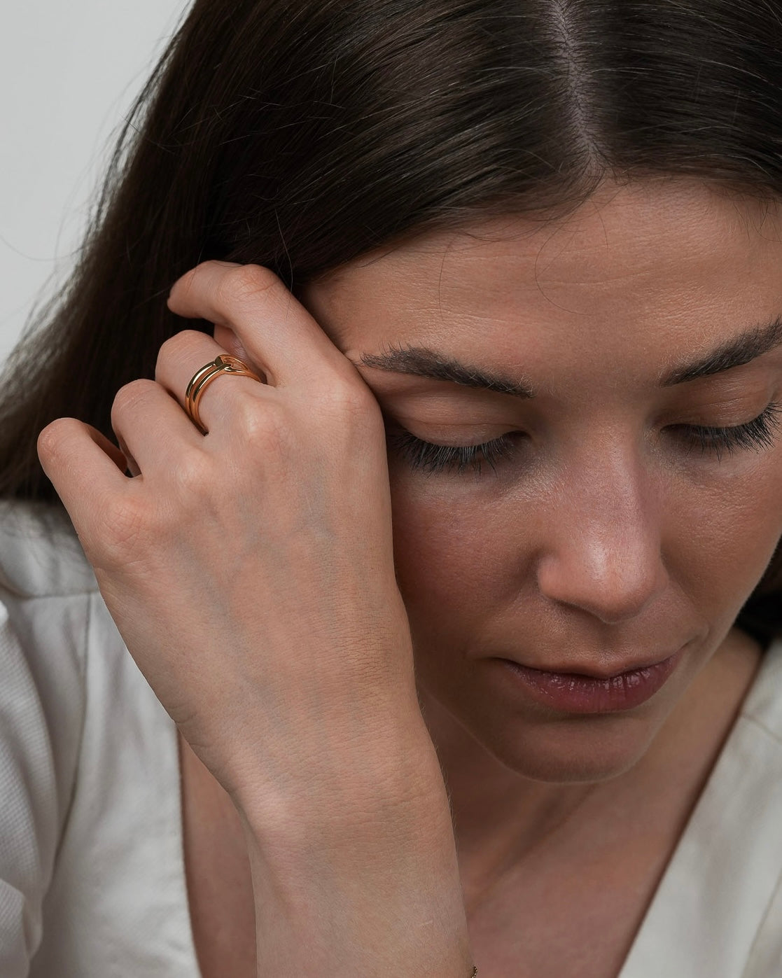 Lifestyle portrait with gold plated ring, subtle jewelry detail on hand