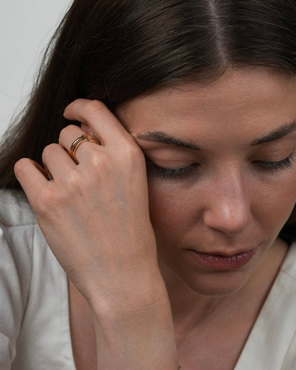 Lifestyle portrait with gold plated ring, subtle jewelry detail on hand