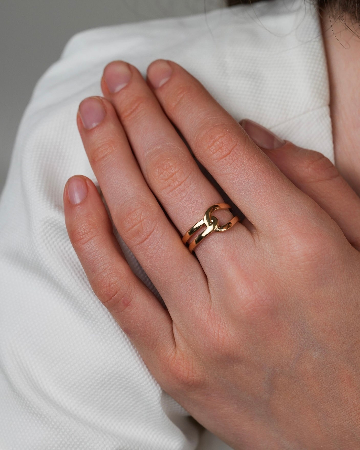 Gold-plated ring worn on hand, everyday jewelry look, soft natural light