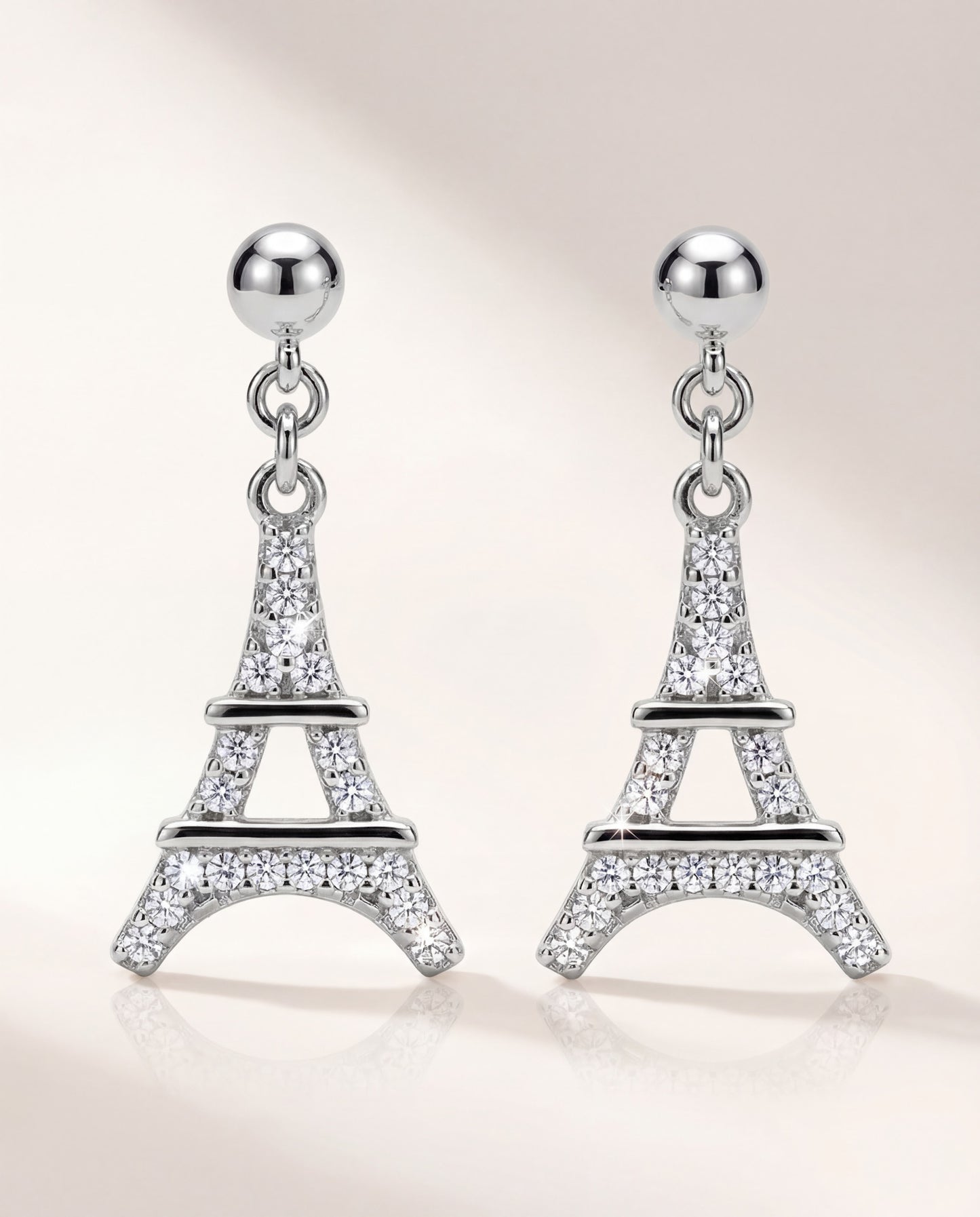 Eiffel Tower dangle earrings in 925 sterling silver with rhodium plating and cubic zirconia, front view