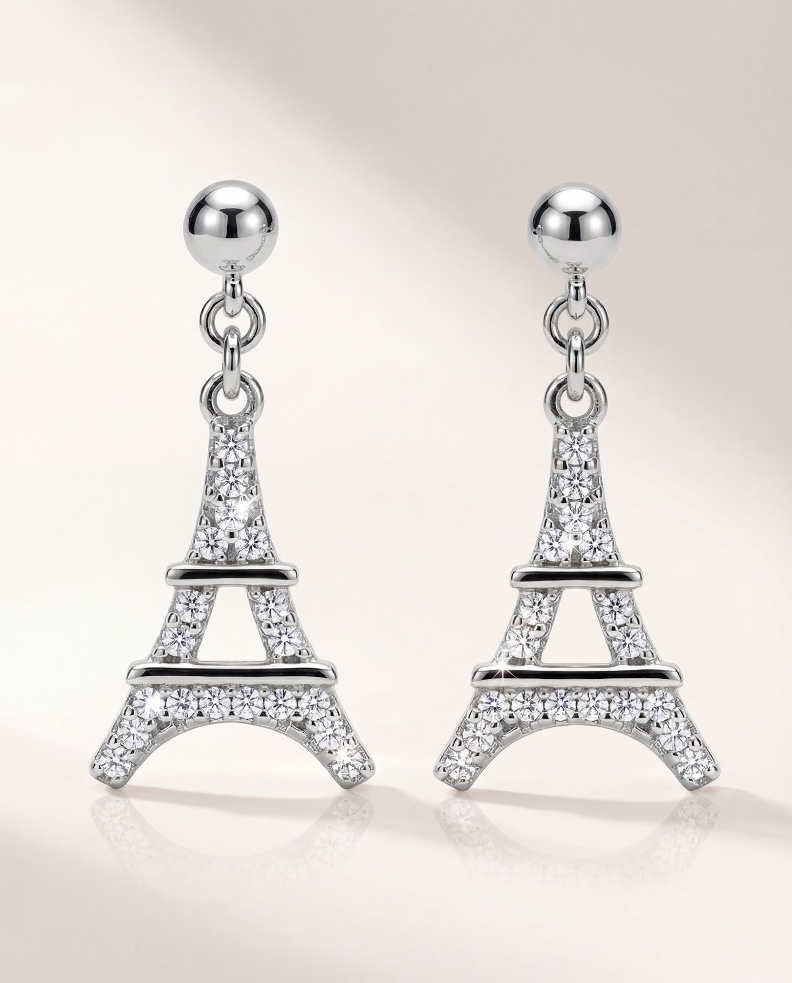Eiffel Tower dangle earrings in 925 sterling silver with rhodium plating and cubic zirconia, front view