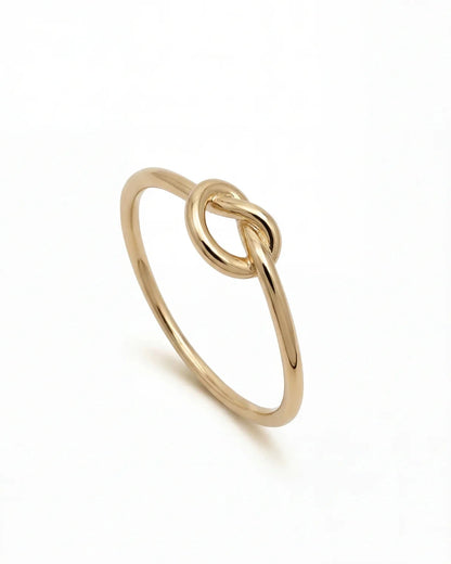 Fira gold knot ring in 18k gold plating, minimalist slim band ring side view on white background
