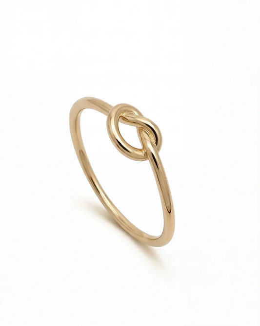 Fira gold knot ring in 18k gold plating, minimalist slim band ring side view on white background