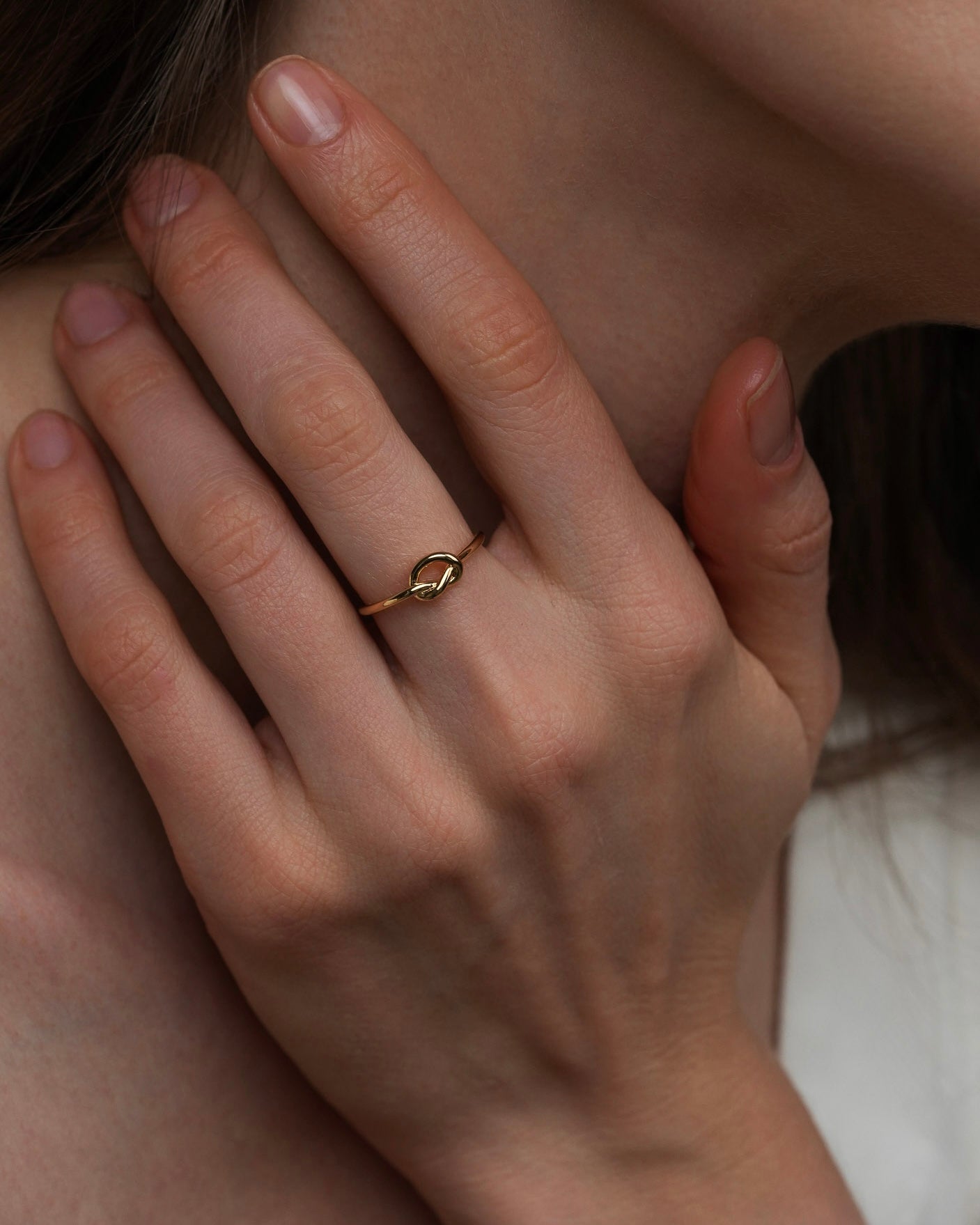 Fira gold knot ring, minimalist 18k gold plated band ring worn on hand