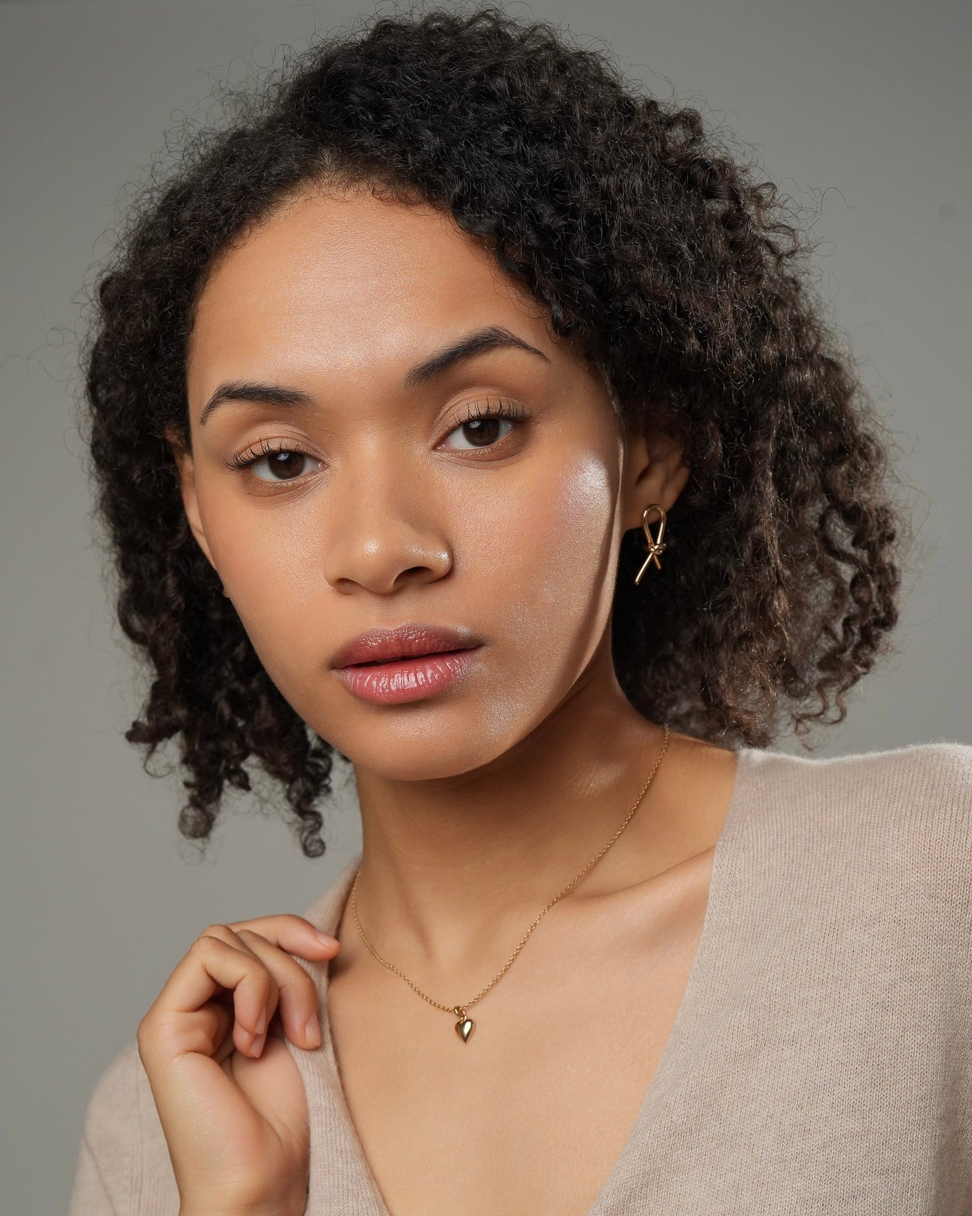 Gold knot stud earrings in 18k gold plating 3 microns worn by model portrait front view