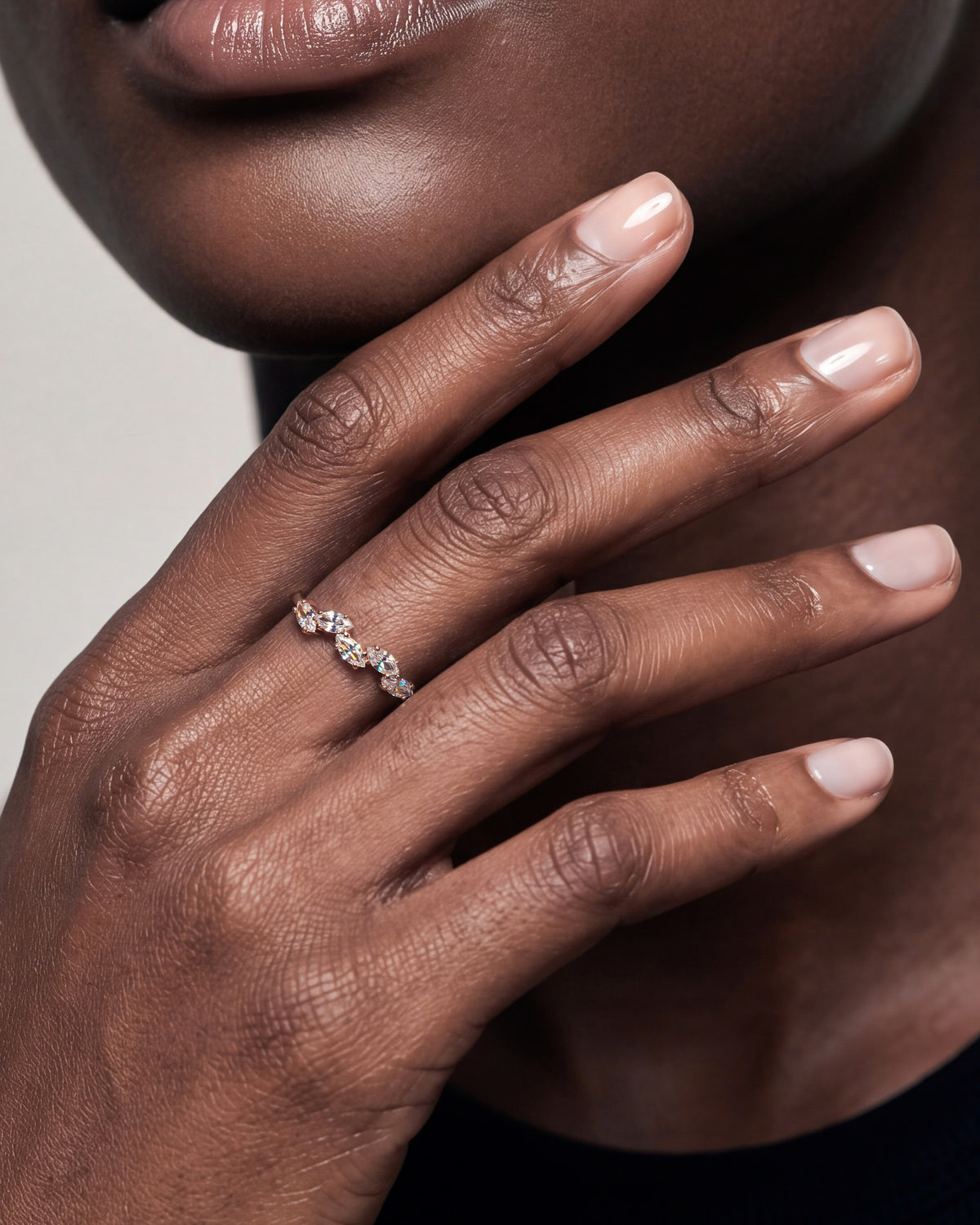 Gold-plated marquise cubic zirconia ring worn on a woman’s hand, close up