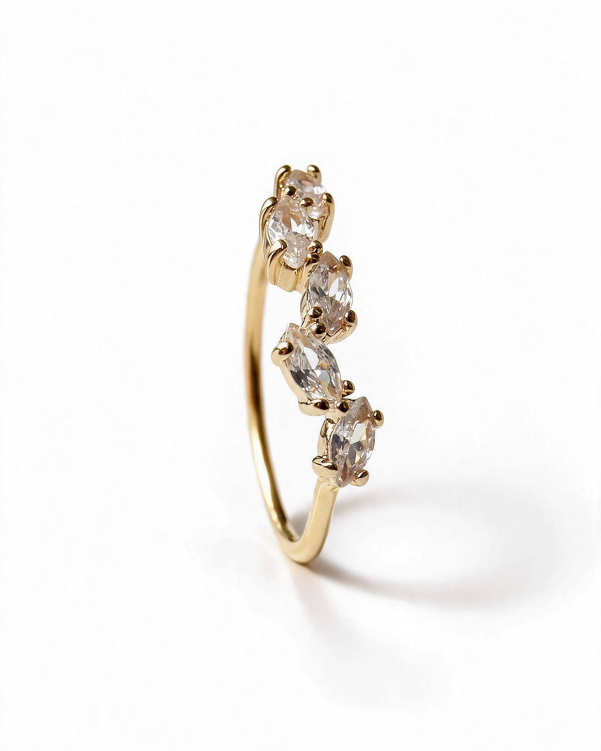 Side view of gold-plated ring with five marquise-cut cubic zirconia stones