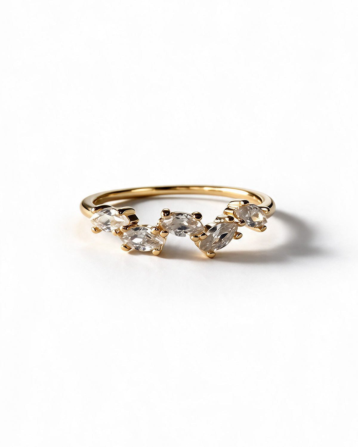 Gold-plated ring with five marquise-cut cubic zirconia stones on white background