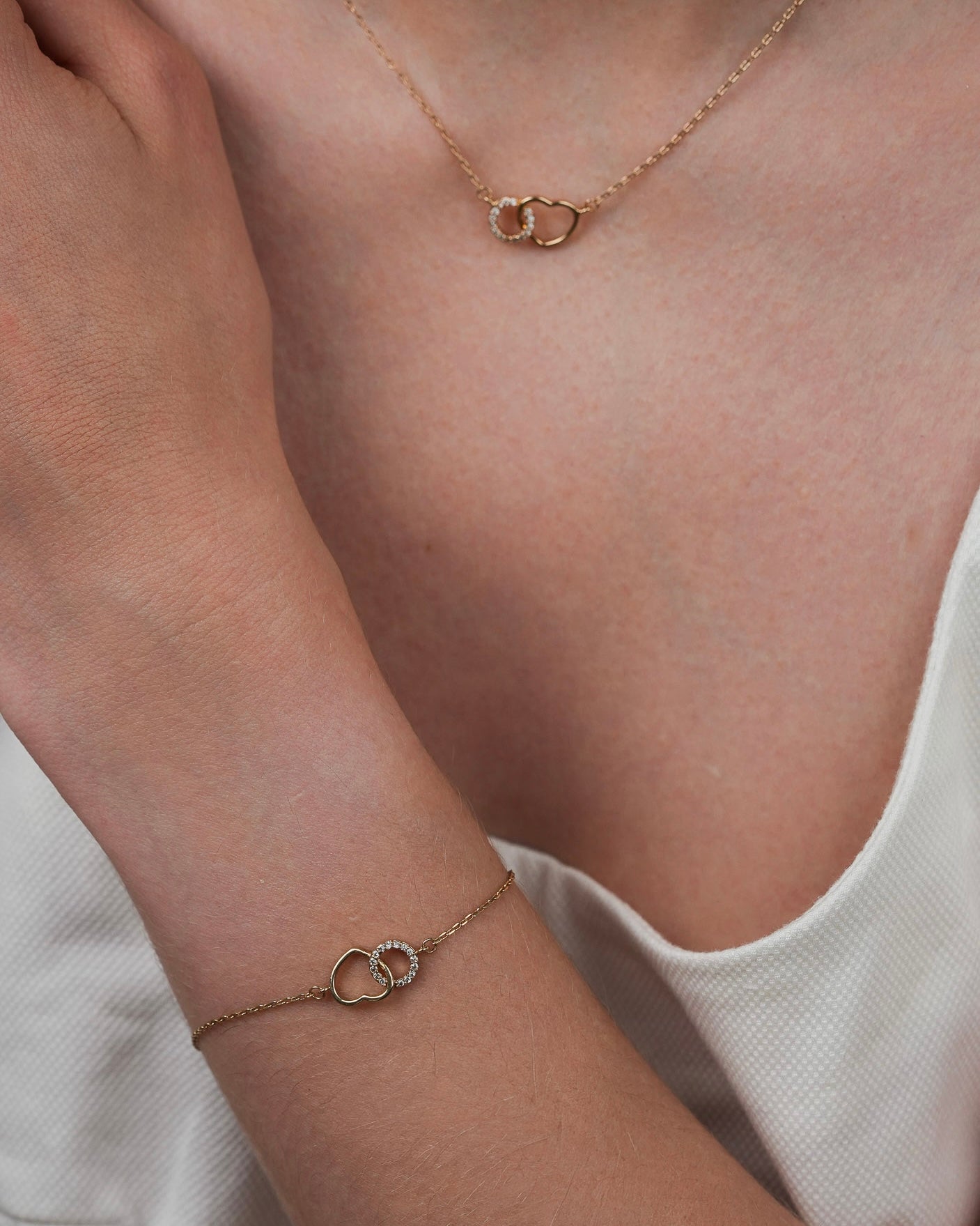 Gold plated heart necklace with cubic zirconia paired with matching bracelet