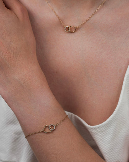 Gold plated heart necklace with cubic zirconia paired with matching bracelet