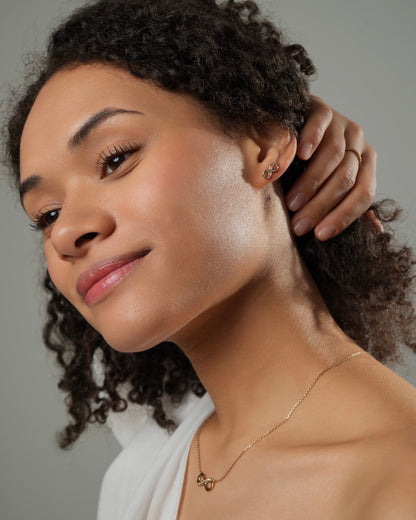 Infinity stud earrings LIA gold plated 18k 3 microns with cubic zirconia, small infinity symbol earrings with matching necklace, side view