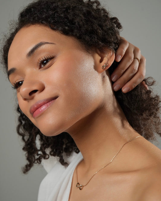 Infinity stud earrings LIA gold plated 18k 3 microns with cubic zirconia, small infinity symbol earrings with matching necklace, side view