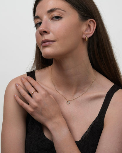 minimalist gold ring with single cubic zirconia, delicate beaded band ring styled with everyday fine jewelry
