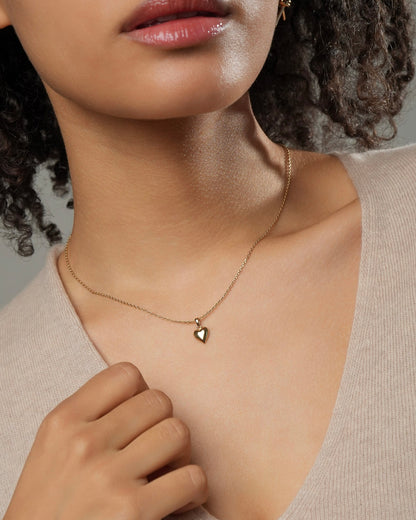 18K gold plated small heart necklace styled on model, delicate everyday gold pendant.
