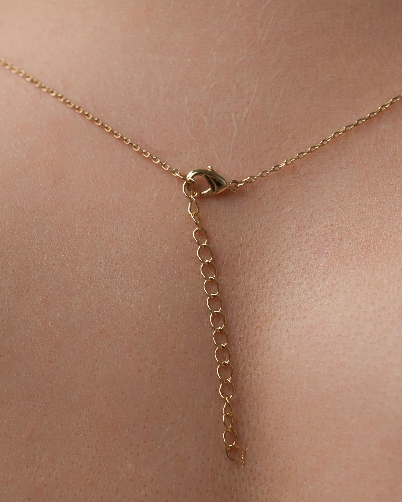 Gold necklace clasp with adjustable extension chain detail