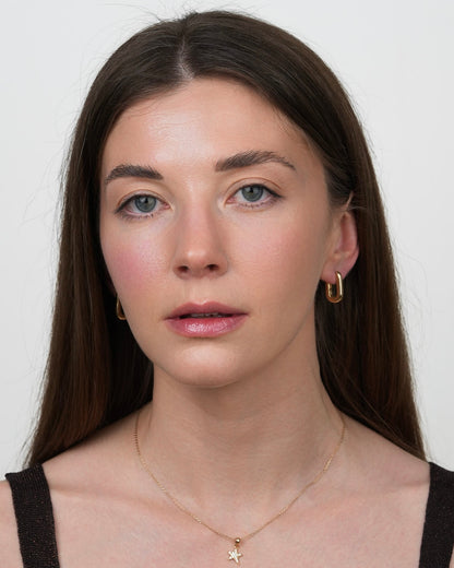 minimalist gold plated hoop earrings rita styled on model, front portrait