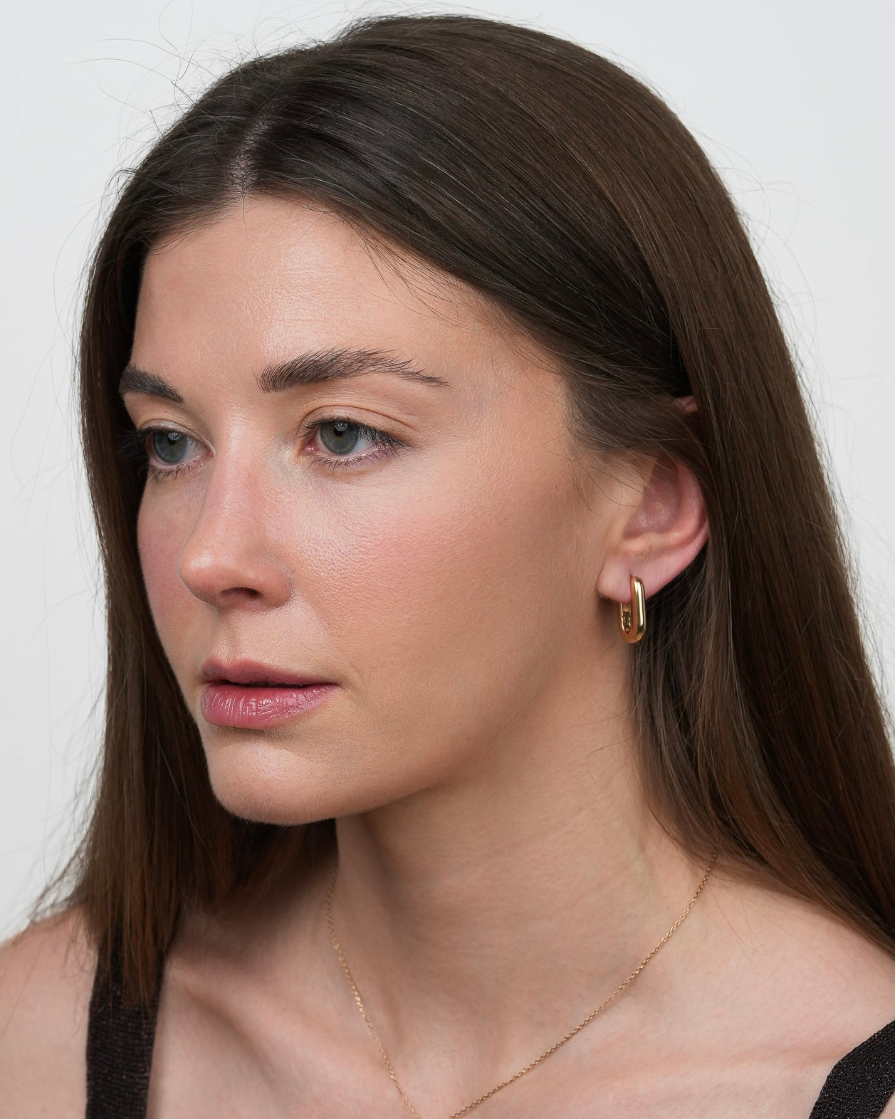 rita gold plated hoop earrings on model, three quarter view
