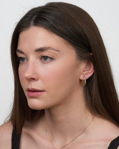rita gold plated hoop earrings on model, three quarter view