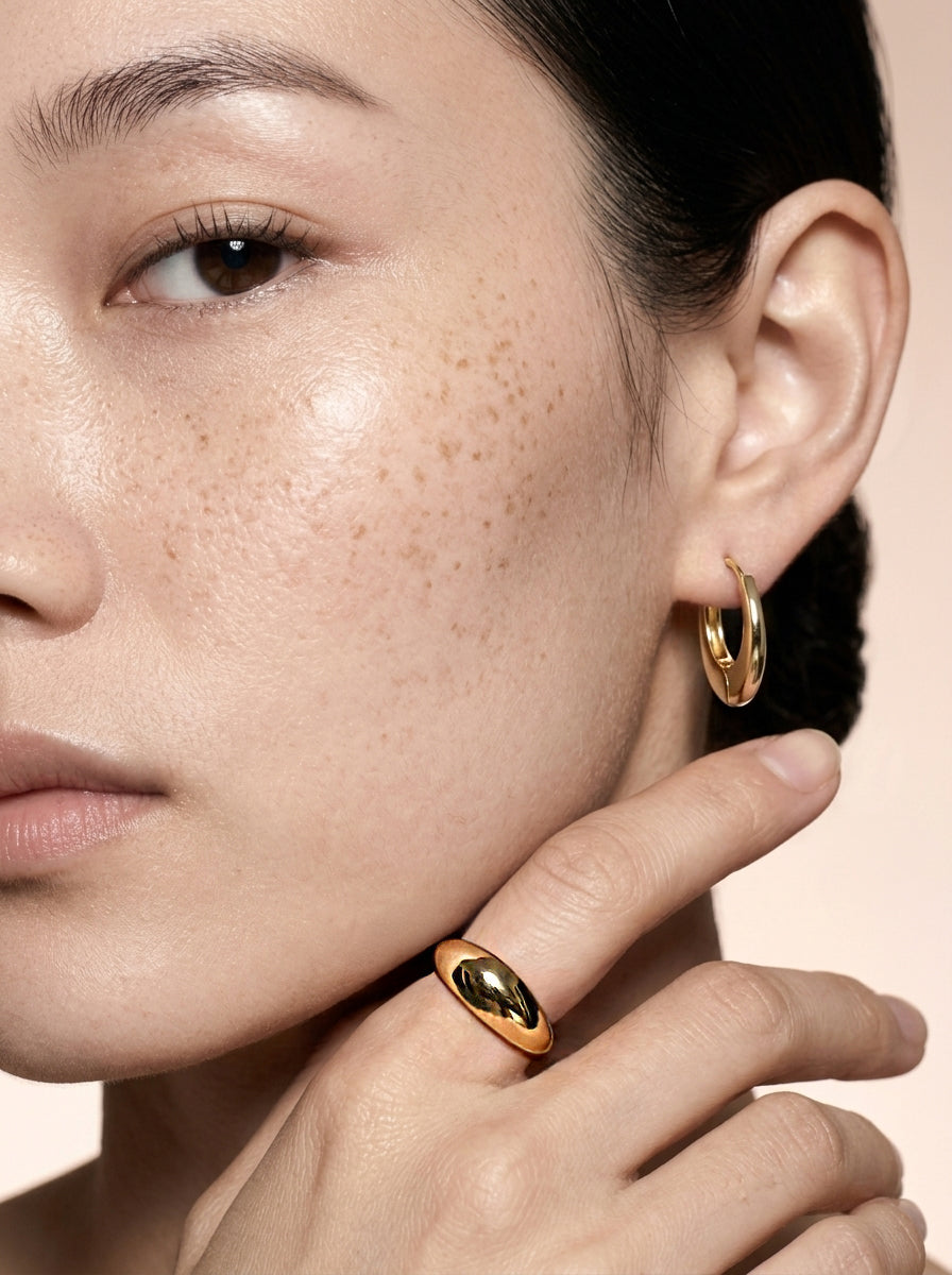 Model wearing an 18K gold-plated chunky dome ring with a high-polish finish