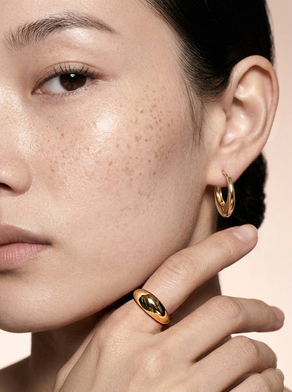 Model wearing an 18K gold-plated chunky dome ring with a high-polish finish