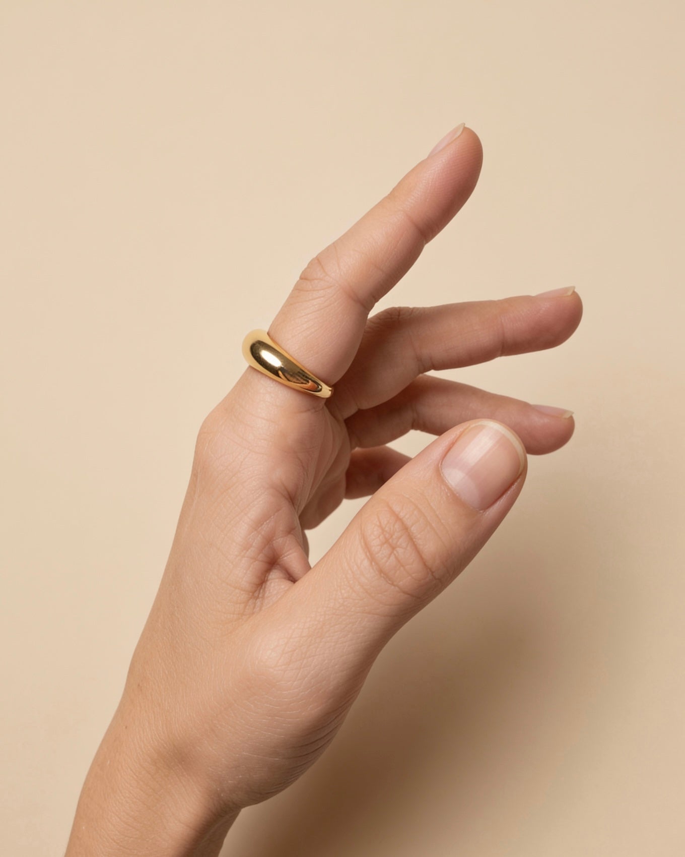 Chunky dome ring with 3-micron 18K gold plating worn on a hand