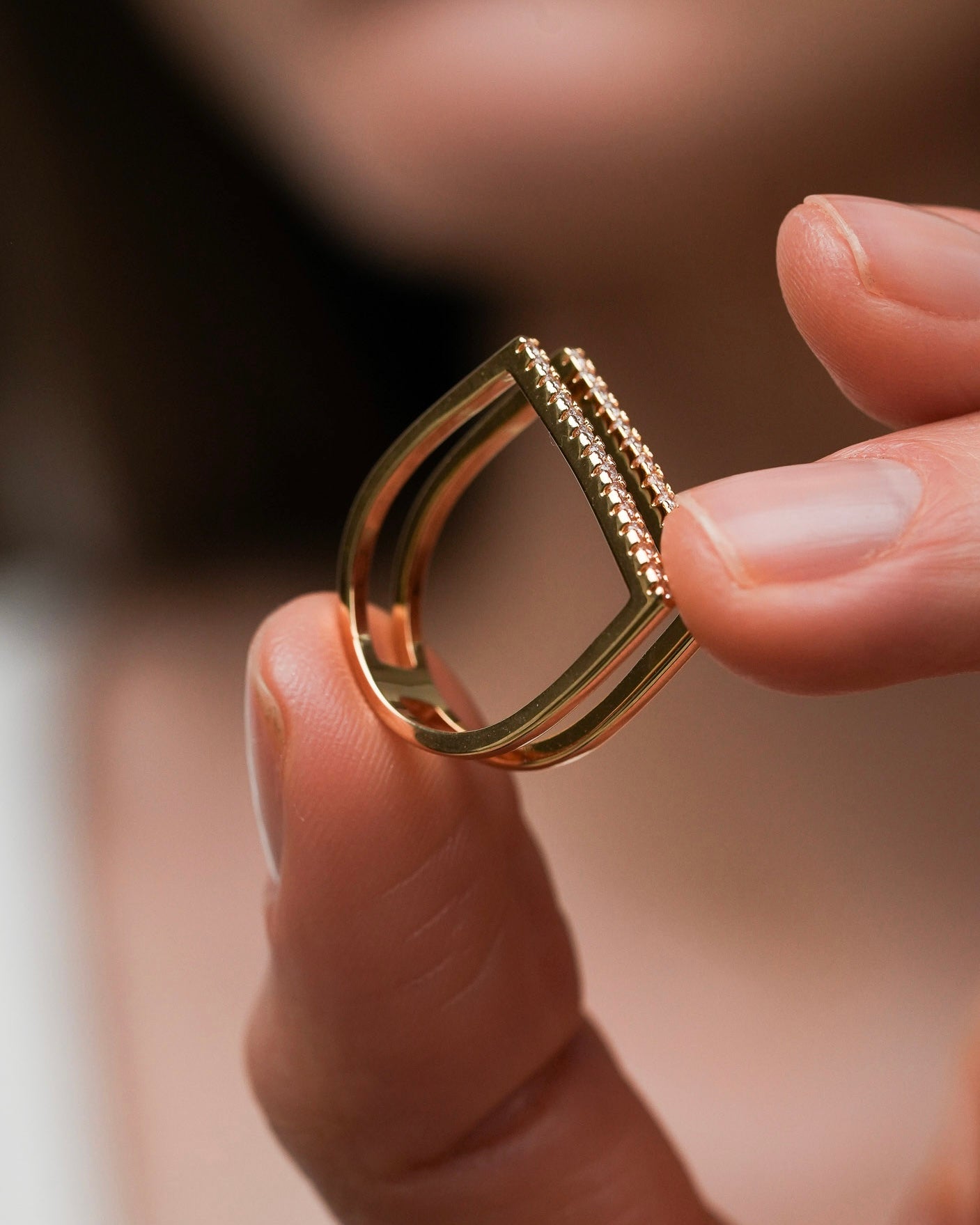 Close up of gold plated bar ring with cubic zirconia – double band statement ring