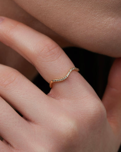 Gold-plated wave ring with cubic zirconia worn on finger