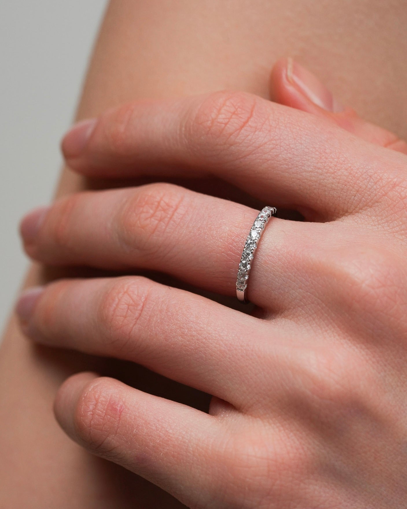 Cubic zirconia half-eternity ring in 925 sterling silver worn on a hand