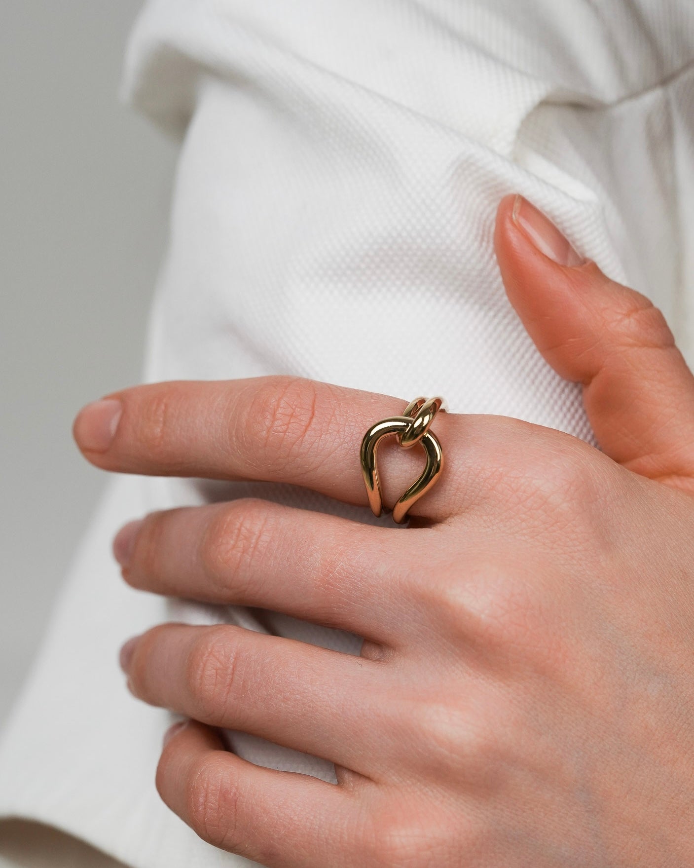 Gold-plated sculptural ring styled for everyday wear on the hand